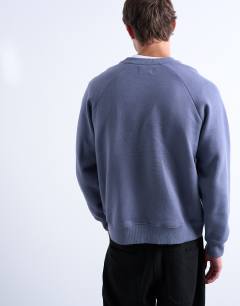 Model wearing Boxy fit raglan sweatshirt in mid blue