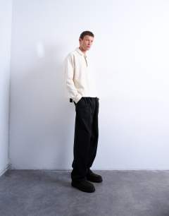 Model wearing Boxy fit textured raglan polo sweat in ecru
