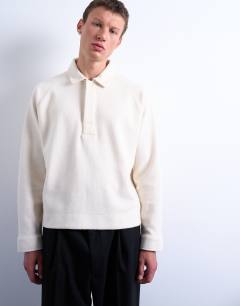 Model wearing Boxy fit textured raglan polo sweat in ecru