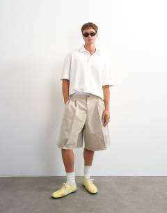 Model wearing Boxy fit textured striped jersey polo in ecru