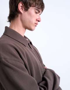 Model wearing Boxy fit waffle polo sweat in brown