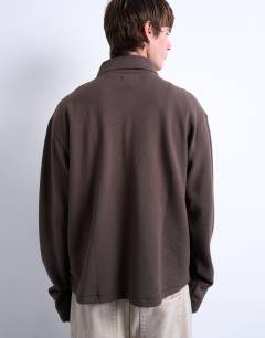 Model wearing Boxy fit waffle polo sweat in brown