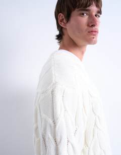 Model wearing Cable knit jumper in cream