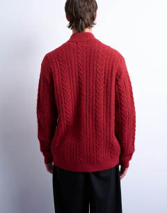 Model wearing Cable knitted zip through funnel neck cardigan in red