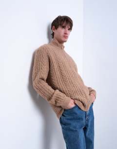 Model wearing Cable knitted zip through funnel neck cardigan in tan