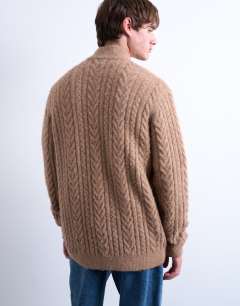 Model wearing Cable knitted zip through funnel neck cardigan in tan
