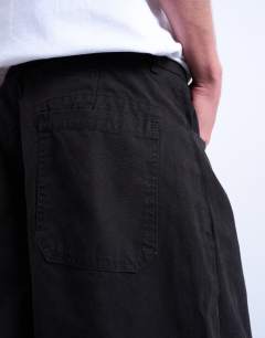 Model wearing Canvas barrel trouser in black