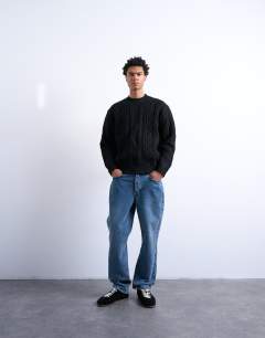 Model wearing Chunky cable knitted jumper in black