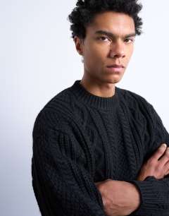 Model wearing Chunky cable knitted jumper in black