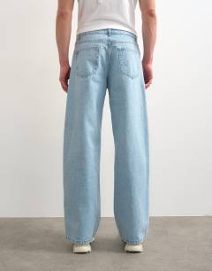 Model wearing Circular design rigid baggy jean in light wash