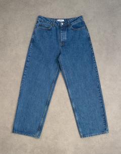 Model wearing Circular design rigid baggy jean in mid wash