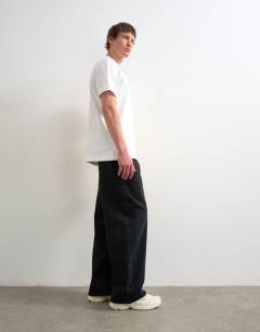 Model wearing Circular design rigid baggy jean in washed black