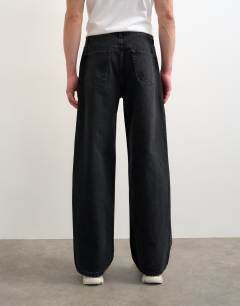 Model wearing Circular design rigid baggy jean in washed black