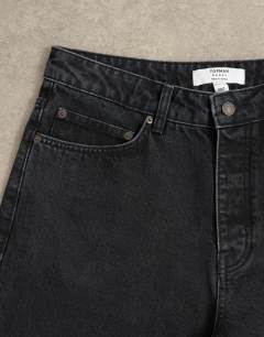 Model wearing Circular design rigid baggy jean in washed black