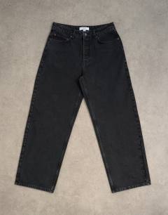 Model wearing Circular design rigid baggy jean in washed black