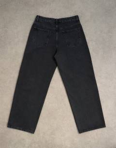 Model wearing Circular design rigid baggy jean in washed black