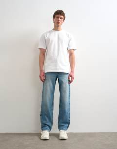 Model wearing Circular design rigid straight jean in mid wash