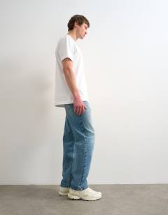 Model wearing Circular design rigid straight jean in mid wash