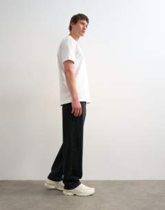 Model wearing Circular design rigid straight jean in washed black