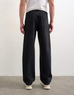 Model wearing Circular design rigid straight jean in washed black