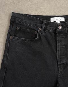 Model wearing Circular design rigid straight jean in washed black