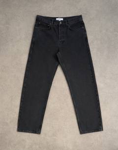 Model wearing Circular design rigid straight jean in washed black