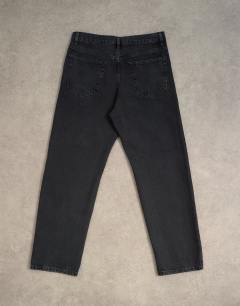 Model wearing Circular design rigid straight jean in washed black