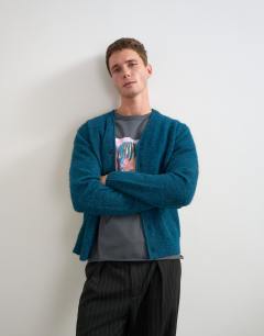 Model wearing Classic fit brushed knitted cardigan in dark teal