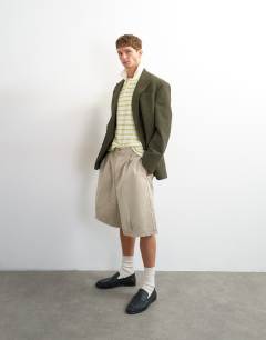 Model wearing Classic fit crochet striped polo in ecru