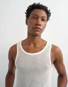 Model wearing Classic fit crochet vest in ecru