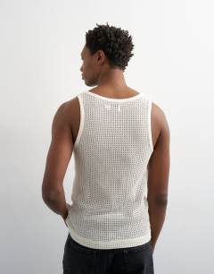 Model wearing Classic fit crochet vest in ecru