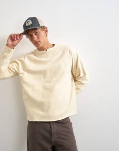 Model wearing Classic fit crop raglan sweatshirt with raw hem in ecru
