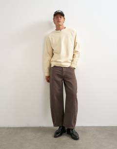Model wearing Classic fit crop raglan sweatshirt with raw hem in ecru