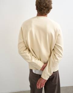 Model wearing Classic fit crop raglan sweatshirt with raw hem in ecru