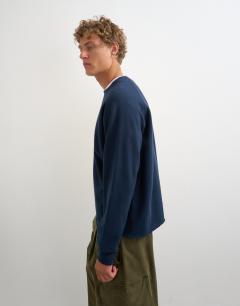 Model wearing Classic fit crop raglan sweatshirt with raw hem in navy