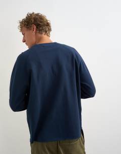 Model wearing Classic fit crop raglan sweatshirt with raw hem in navy