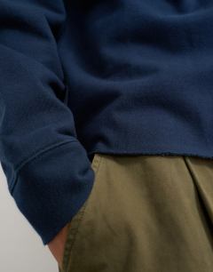Model wearing Classic fit crop raglan sweatshirt with raw hem in navy
