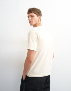 Model wearing Classic fit distressed raw hem t-shirt in ecru
