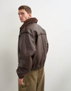 Model wearing Classic fit faux leather bomber jacket with detachable faux fur collar in chocolate brown