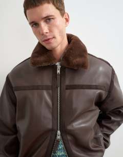 Model wearing Classic fit faux leather bomber jacket with detachable faux fur collar in chocolate brown