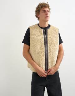 Model wearing Classic fit faux leather reversible shearling gilet in brown