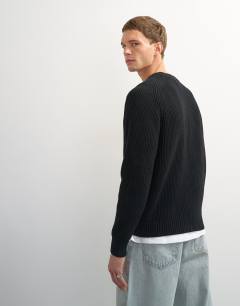 Model wearing Classic fit fisherman knit jumper in black