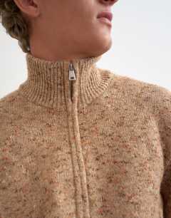 Model wearing Classic fit funnel neck nep jumper with double zip in stone