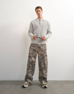 Model wearing Classic fit knitted polo in grey