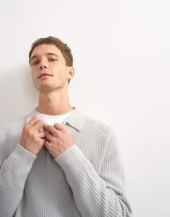Model wearing Classic fit knitted polo in grey