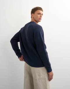 Model wearing Classic fit knitted polo in navy