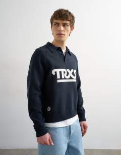 Model wearing Classic fit knitted rugby polo with applique text in navy