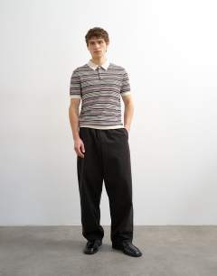 Model wearing Classic fit knitted stripe polo in cream