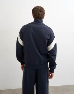 Model wearing Classic fit paneled pique track top in navy