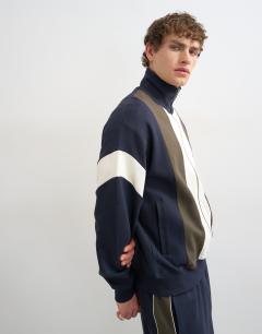 Model wearing Classic fit paneled pique track top in navy